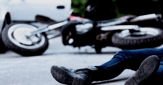 man injured next to motorcycle