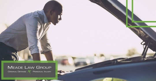 Man looking inside a car